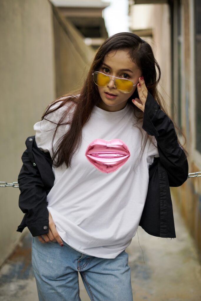 Woman wearing white tshirt with pink kiss on the front