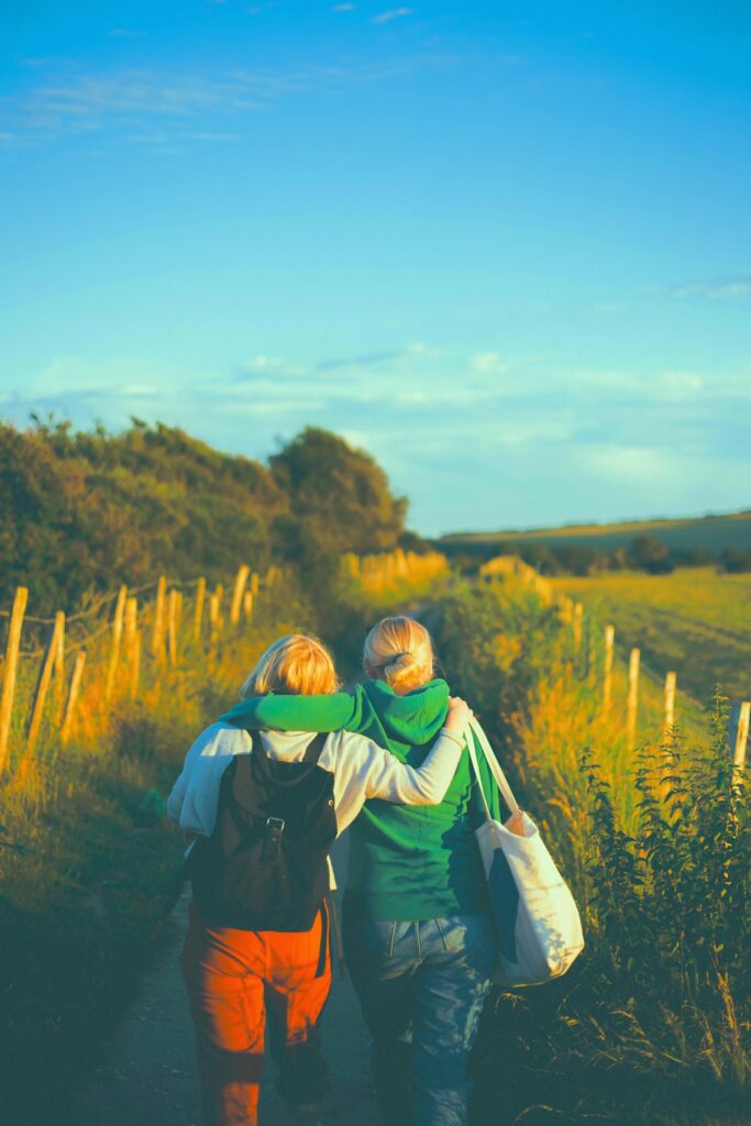 two women standing in a field