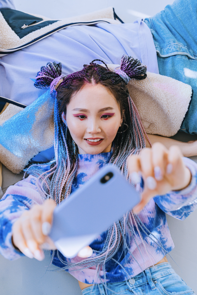Asian girl wearing purple hoodie taking a selfie