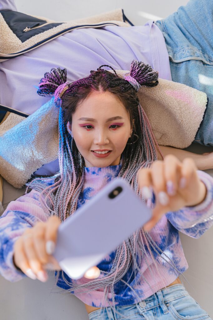 Asian girl wearing purple hoodie taking a selfie