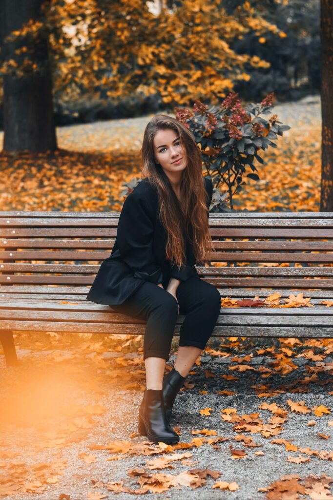 woman sitting on a bench in fall